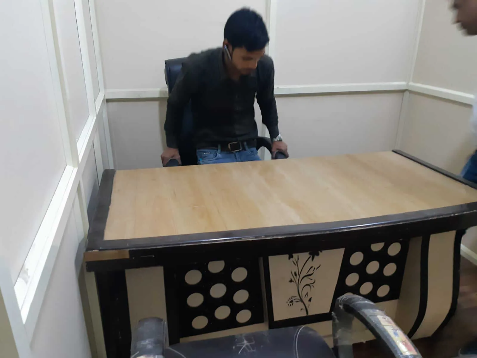 A volunteer moving a desk into place as the foundation's office is set up.